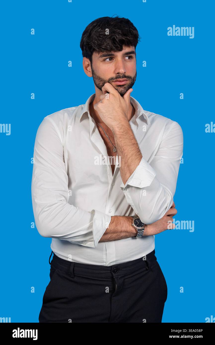 Man with beard and white shirt contemplating, finding solutions Stock Photo