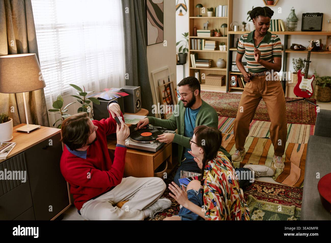 Diverse Adult Friends Dancing and Playing Vinyl at Home Gathering Stock Photo