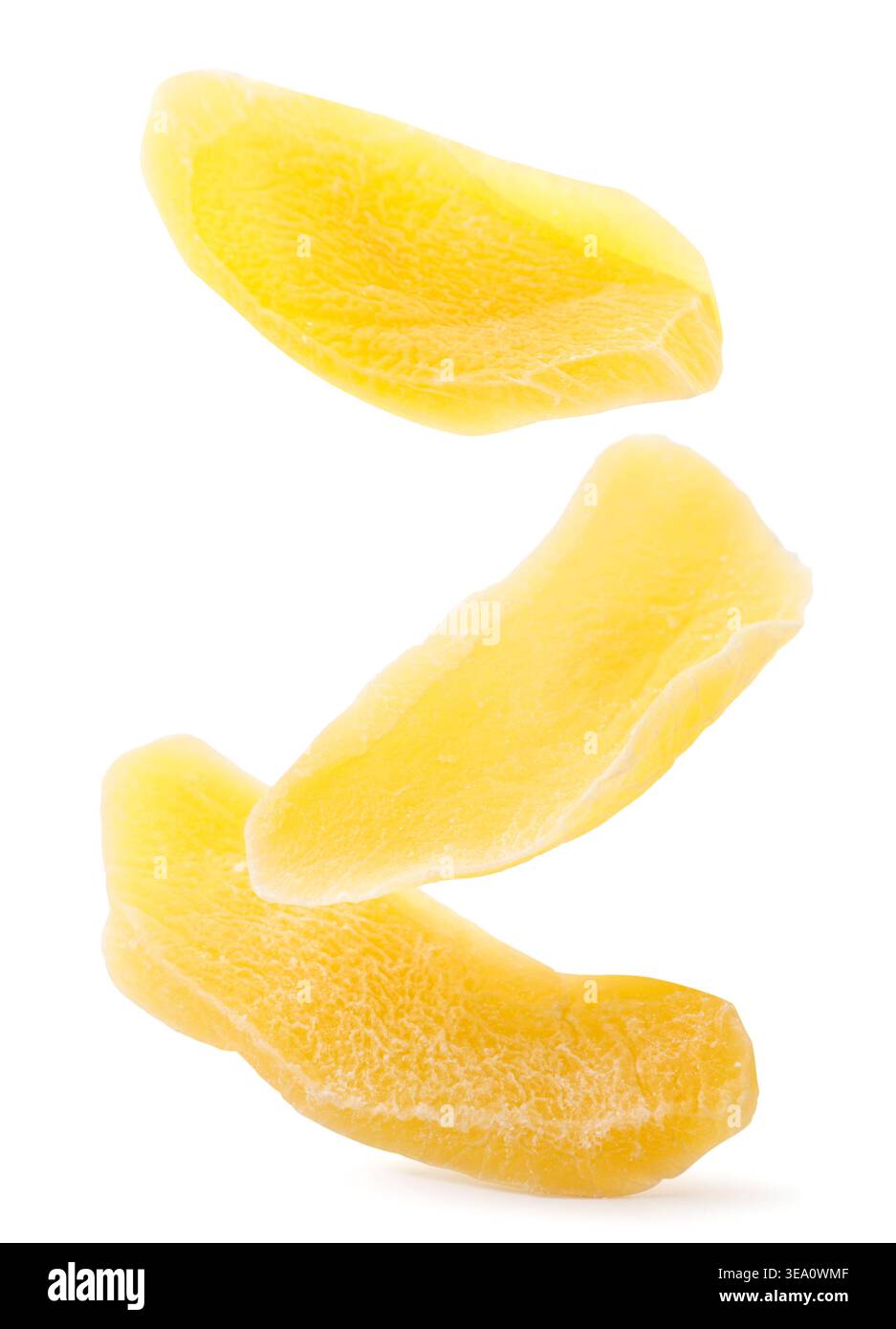 Dried mango slices falling close-up on a white background. Isolated Stock Photo