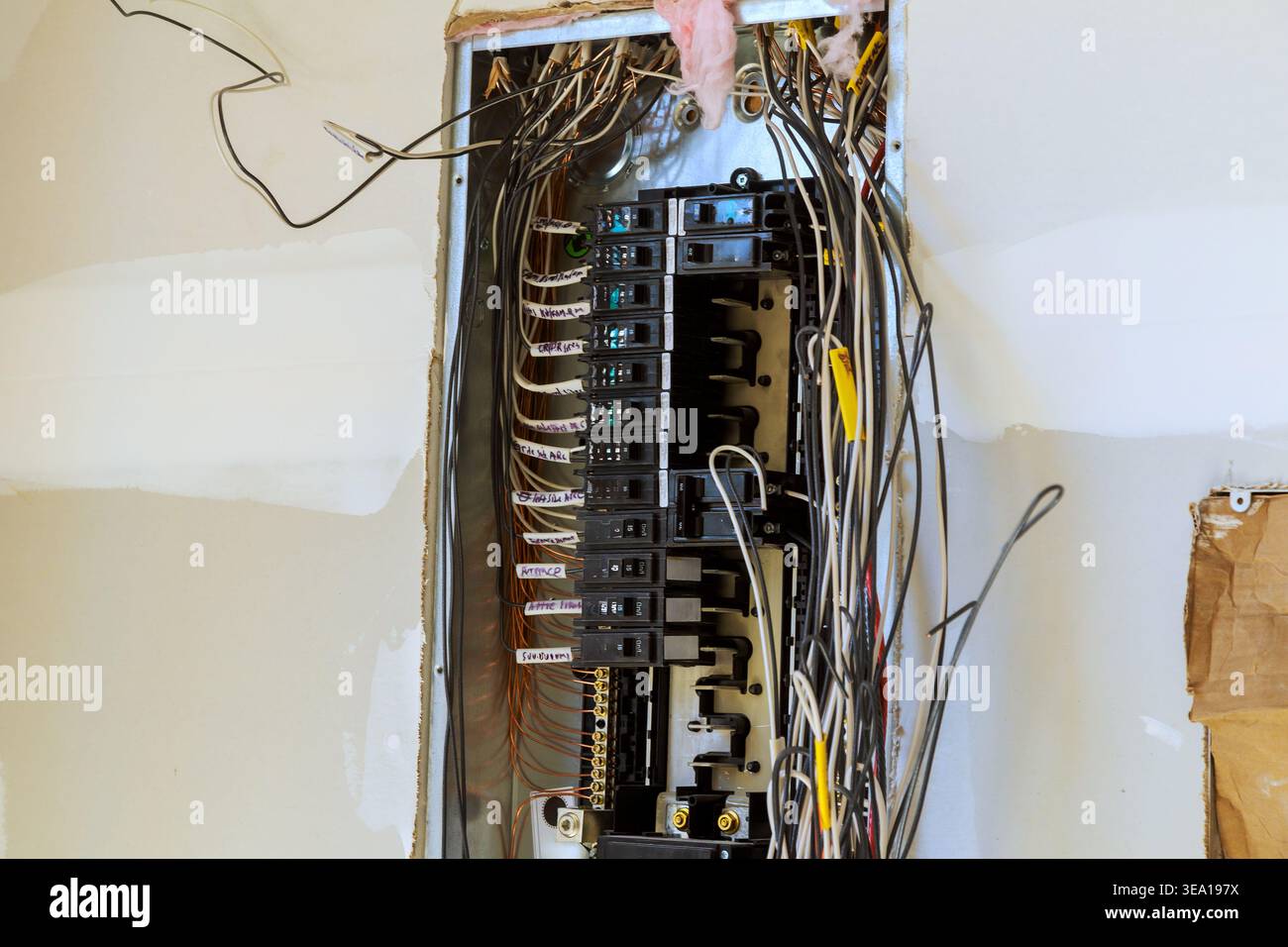 Main electric panel shows various breakers wiring during home renovation work progress. Stock Photo