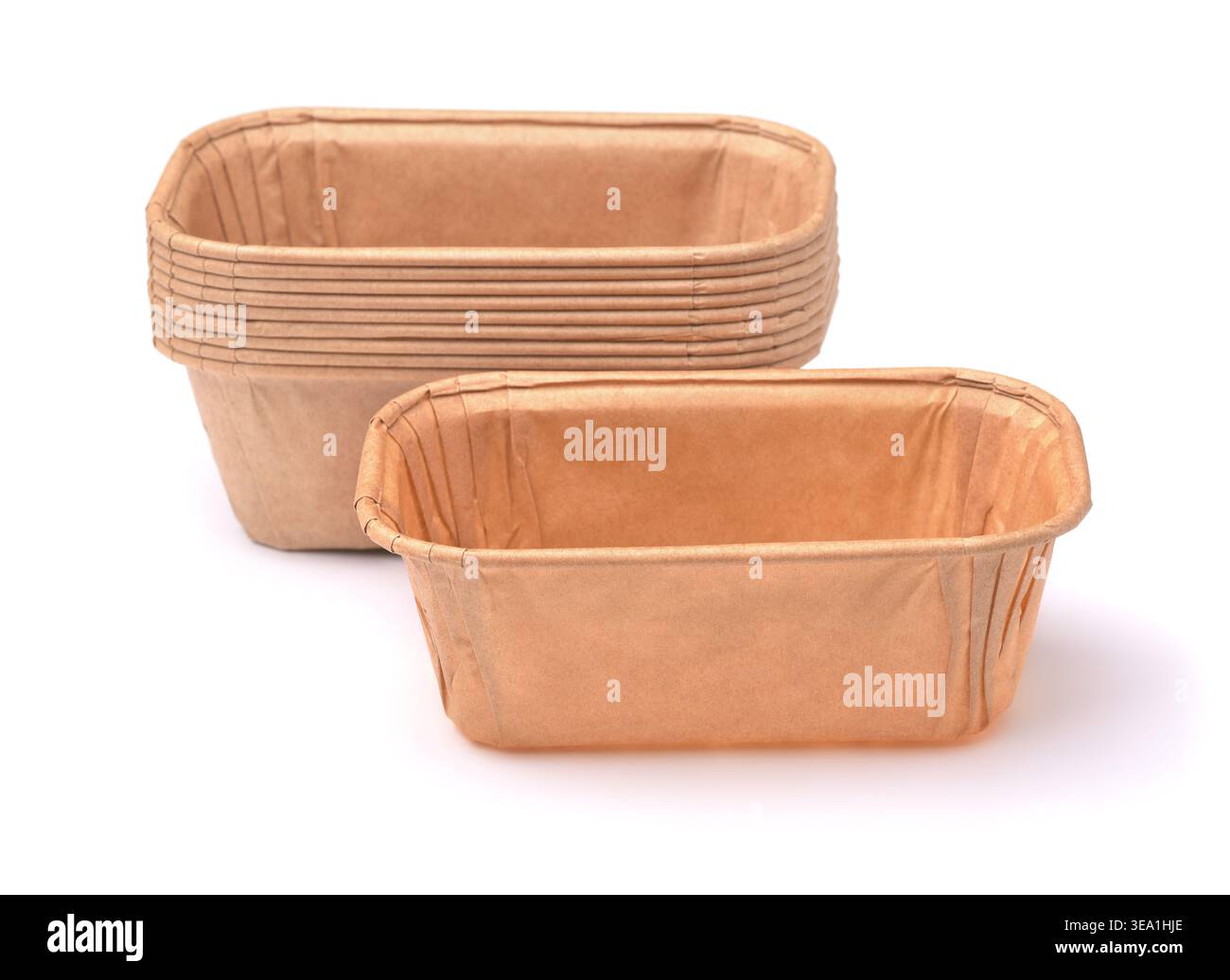 Stack of empty disposable rectangular brown paper baking molds isolated on white Stock Photo