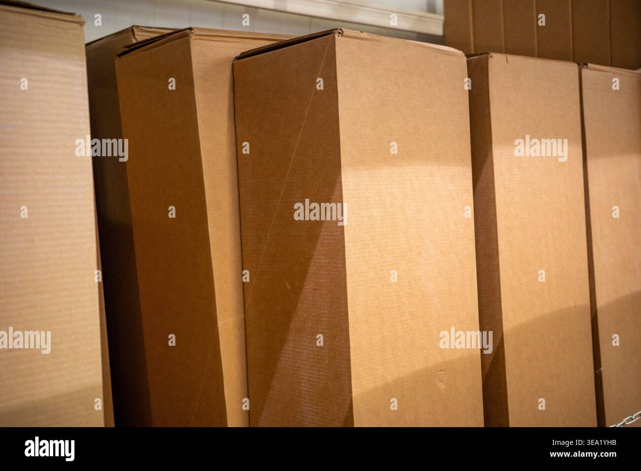 cardboard boxes stacked in warehouse storage, shipping packaging containers. Concept: e-commerce logistics Stock Photo