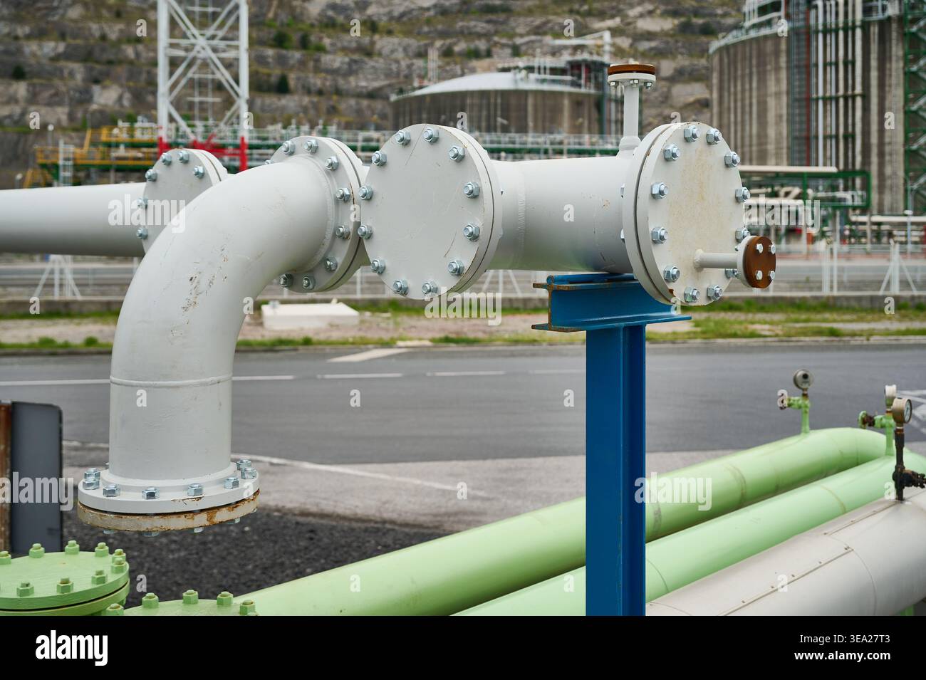 Industrial pipes and pipelines forming a complex grid, transporting fluids and gases in a petroleum refinery or chemical plant Stock Photo