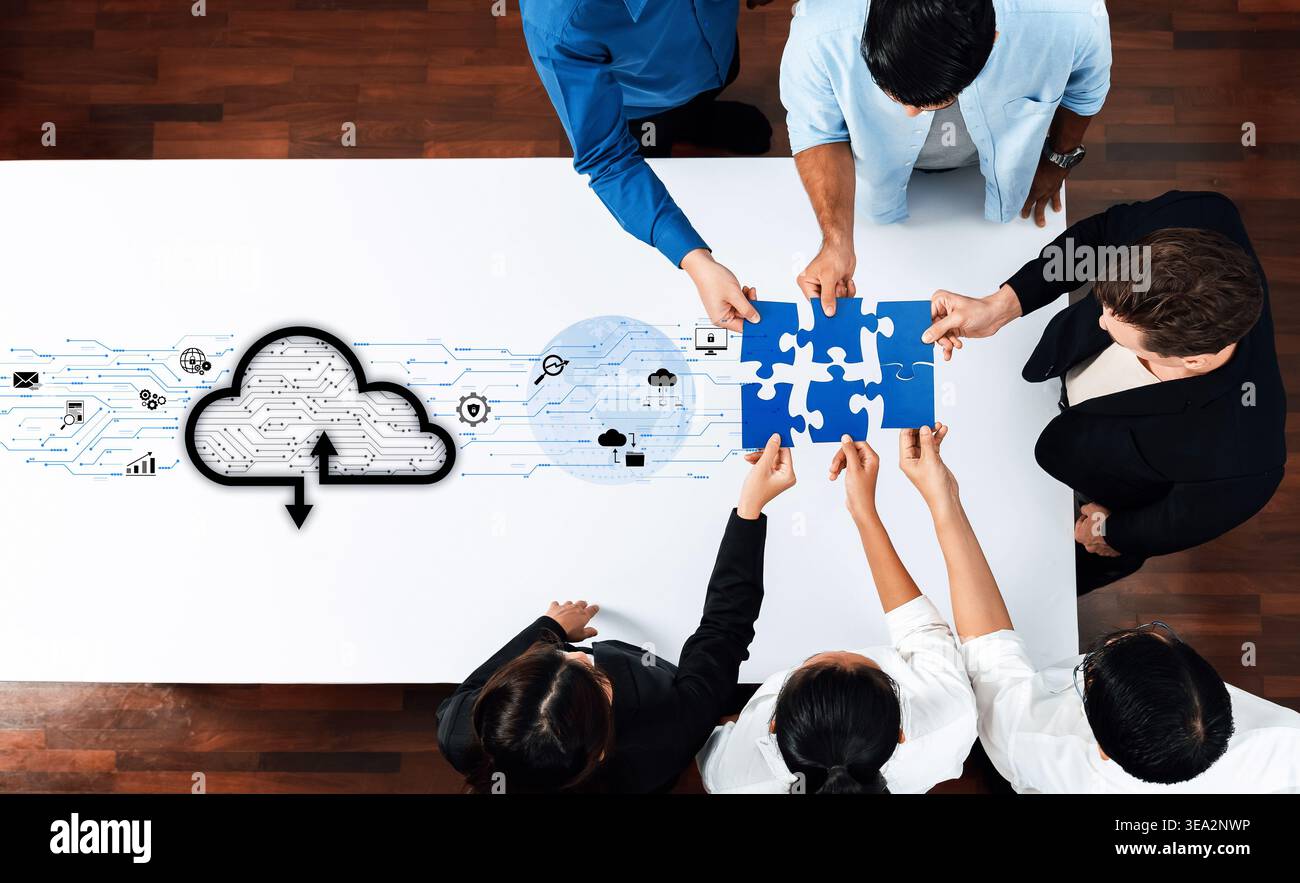 A diverse group of professionals collaborates on a cloud technology project, assembling a puzzle symbolizing innovative problem-solving and teamwork Stock Photo