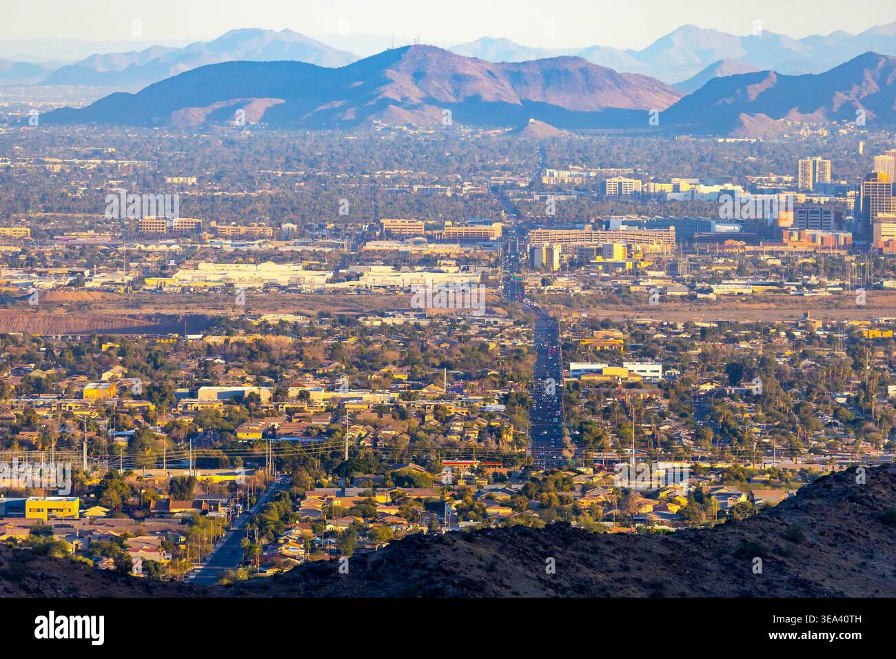 Aerial perspective shows multilane highway traffic and urban infrastructure across Phoenix Arizona Stock Photo