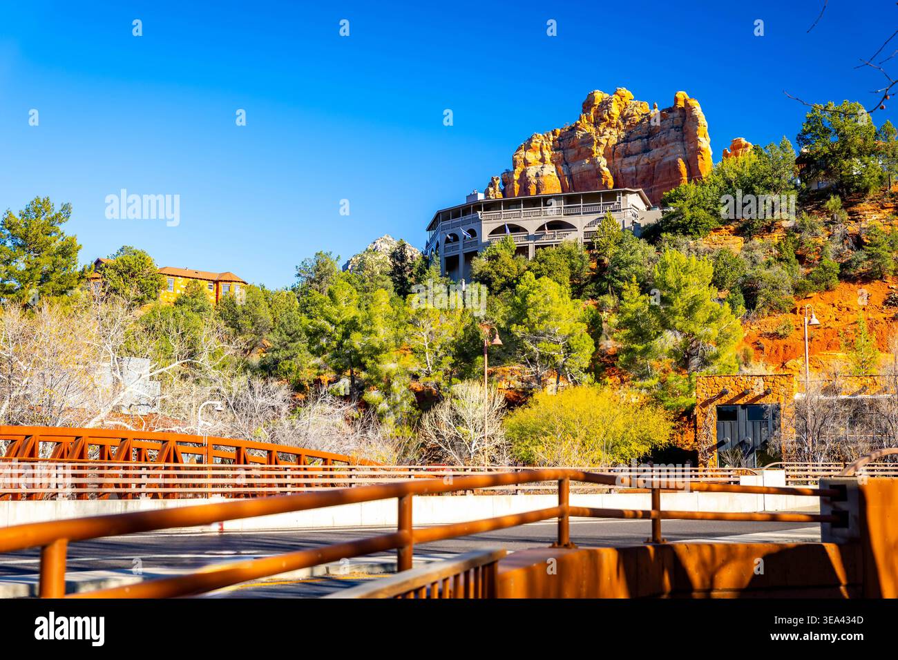 Downtown Sedona buildings sit beneath iconic red rock formations in the ...