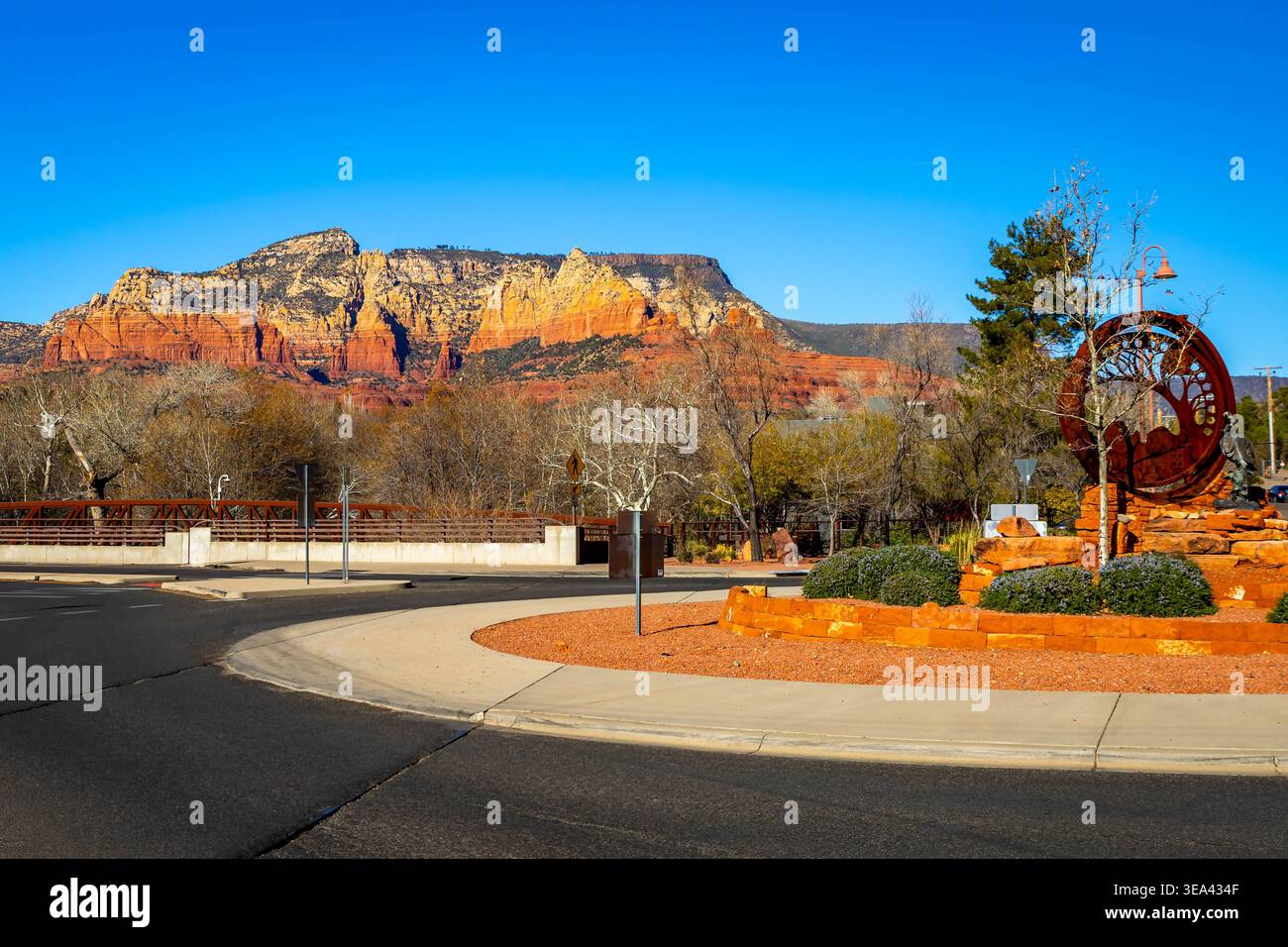 Downtown Sedona buildings sit beneath iconic red rock formations in the ...