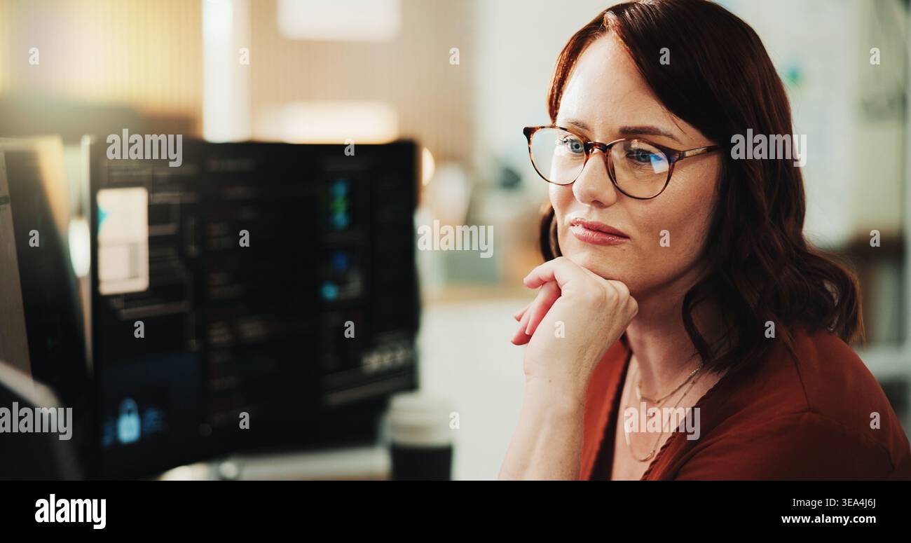 Computer, programmer and thinking with woman in office for coding, cyber security or cloud computing. Programming, research and developer with person Stock Photo