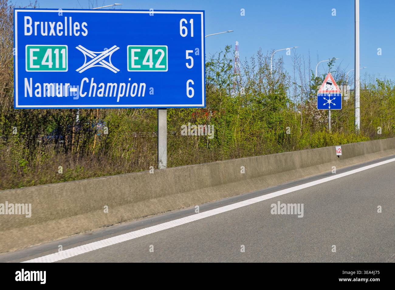 Namur, Belgium, April 8, 2026. Blue highway sign showing distances to Brussels and Namur-Champion at a major road junction. Stock Photo
