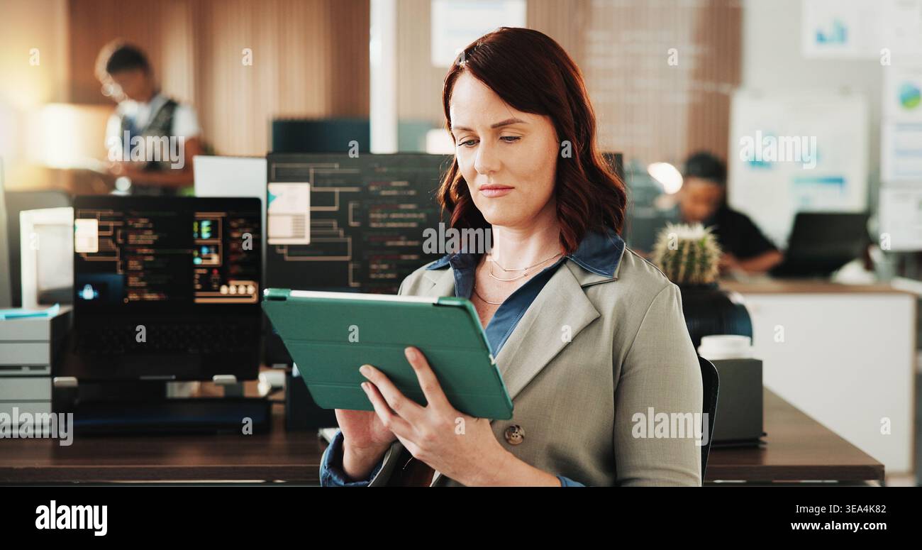 Tablet, programmer and research with woman in office for coding, cyber security and cloud computing. Programming, reading and developer with employee Stock Photo