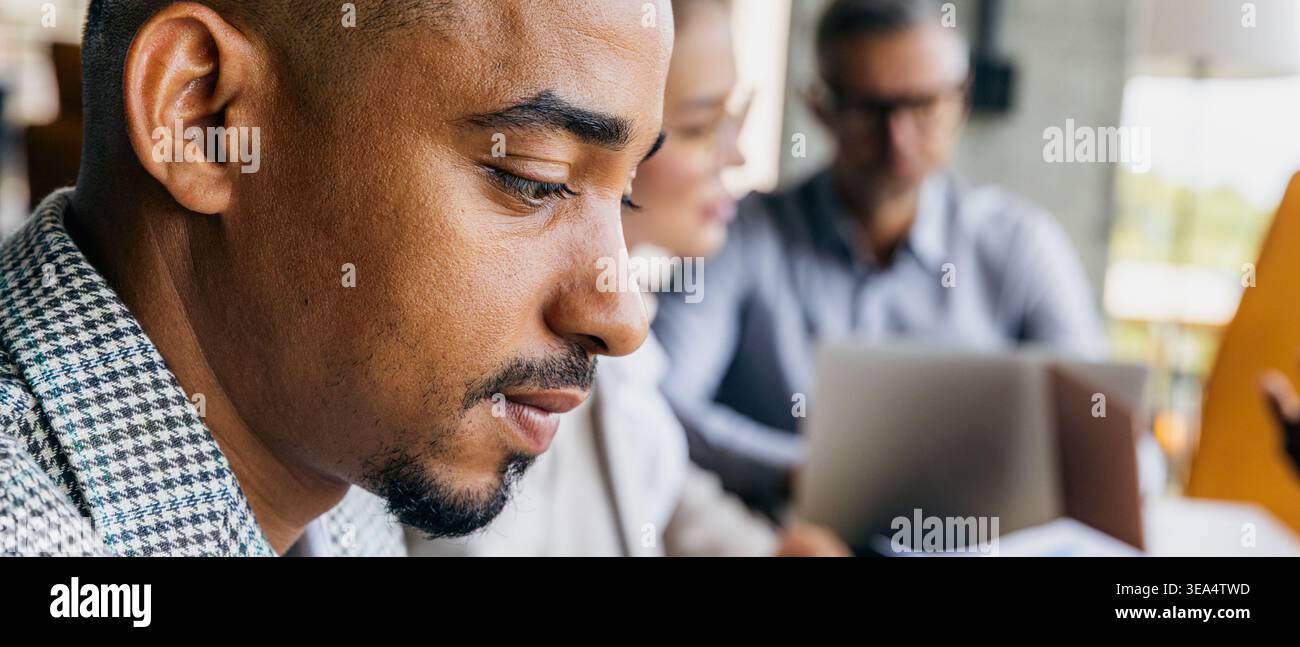 Dedicated analyst thoroughly assesses KPI data in office environment Stock Photo