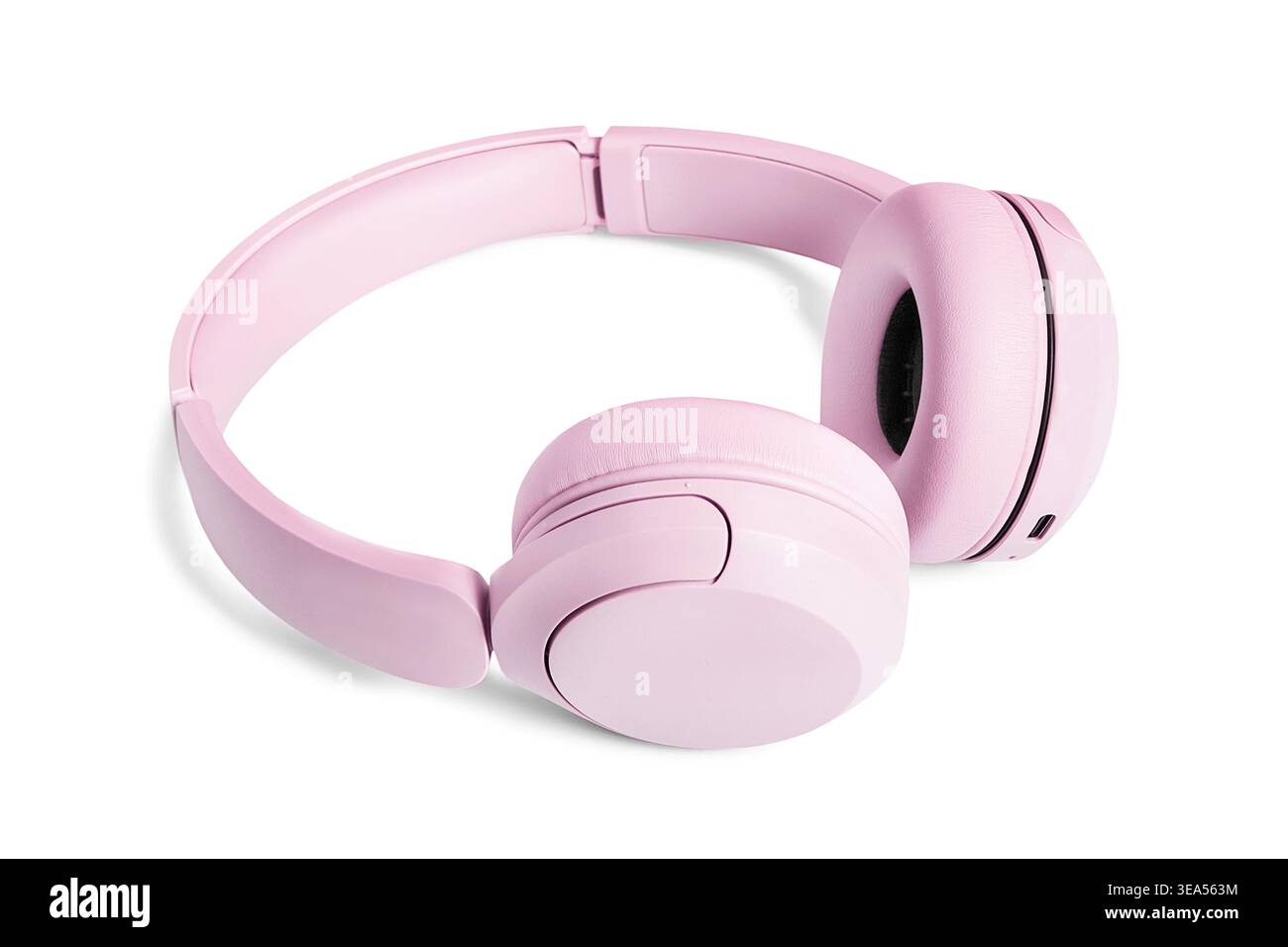 Pink wireless headphones lying on white background Stock Photo