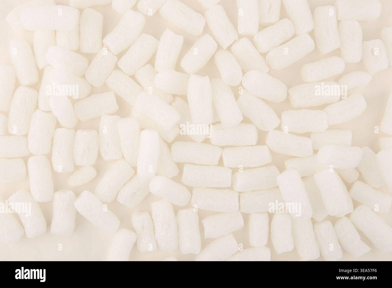 Styrofoam packing peanuts  background. White plastic foam pellets protective for parcel packing. Stock Photo
