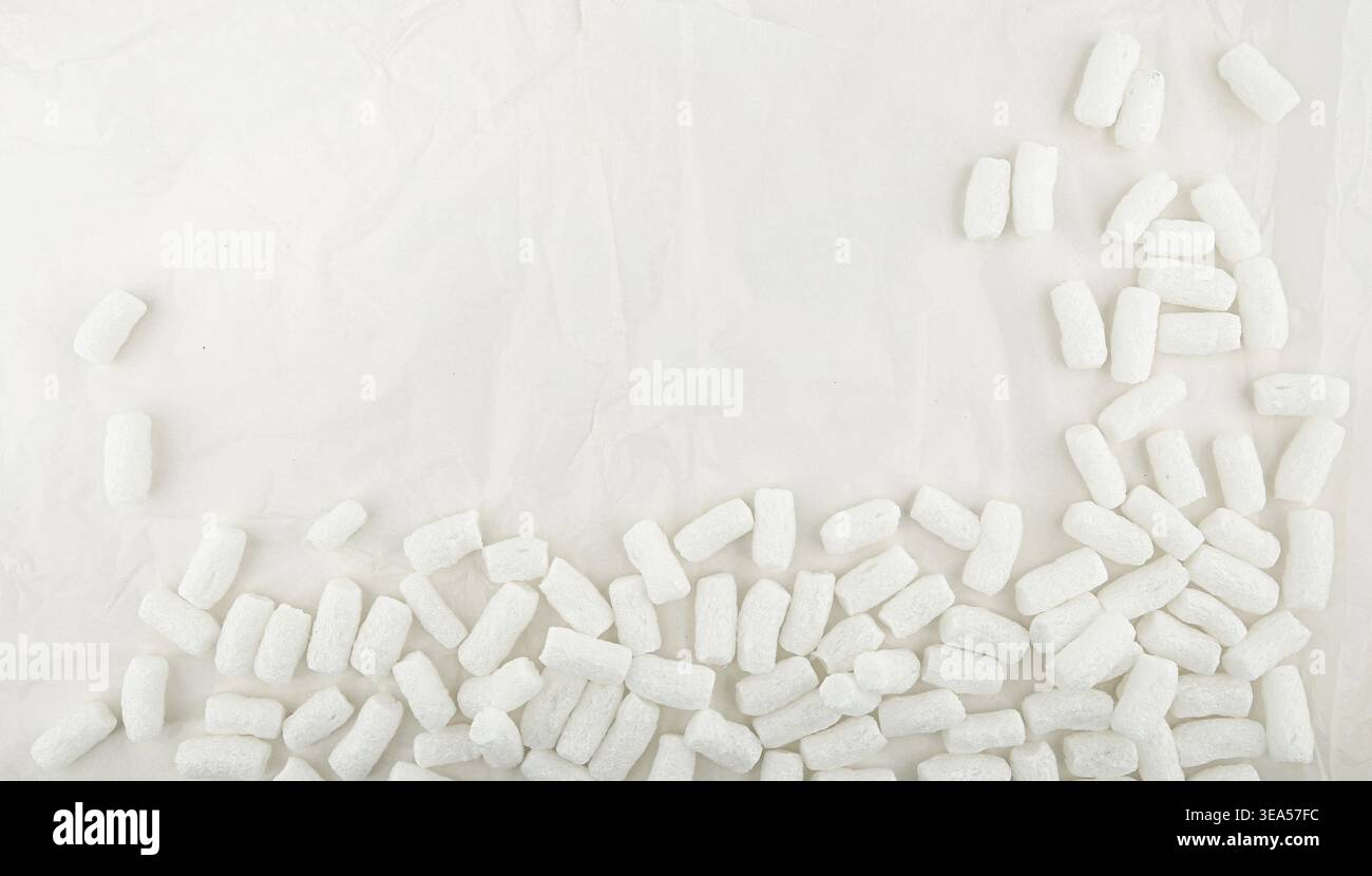 Styrofoam packing peanuts  background. White plastic foam pellets protective for parcel packing. Stock Photo