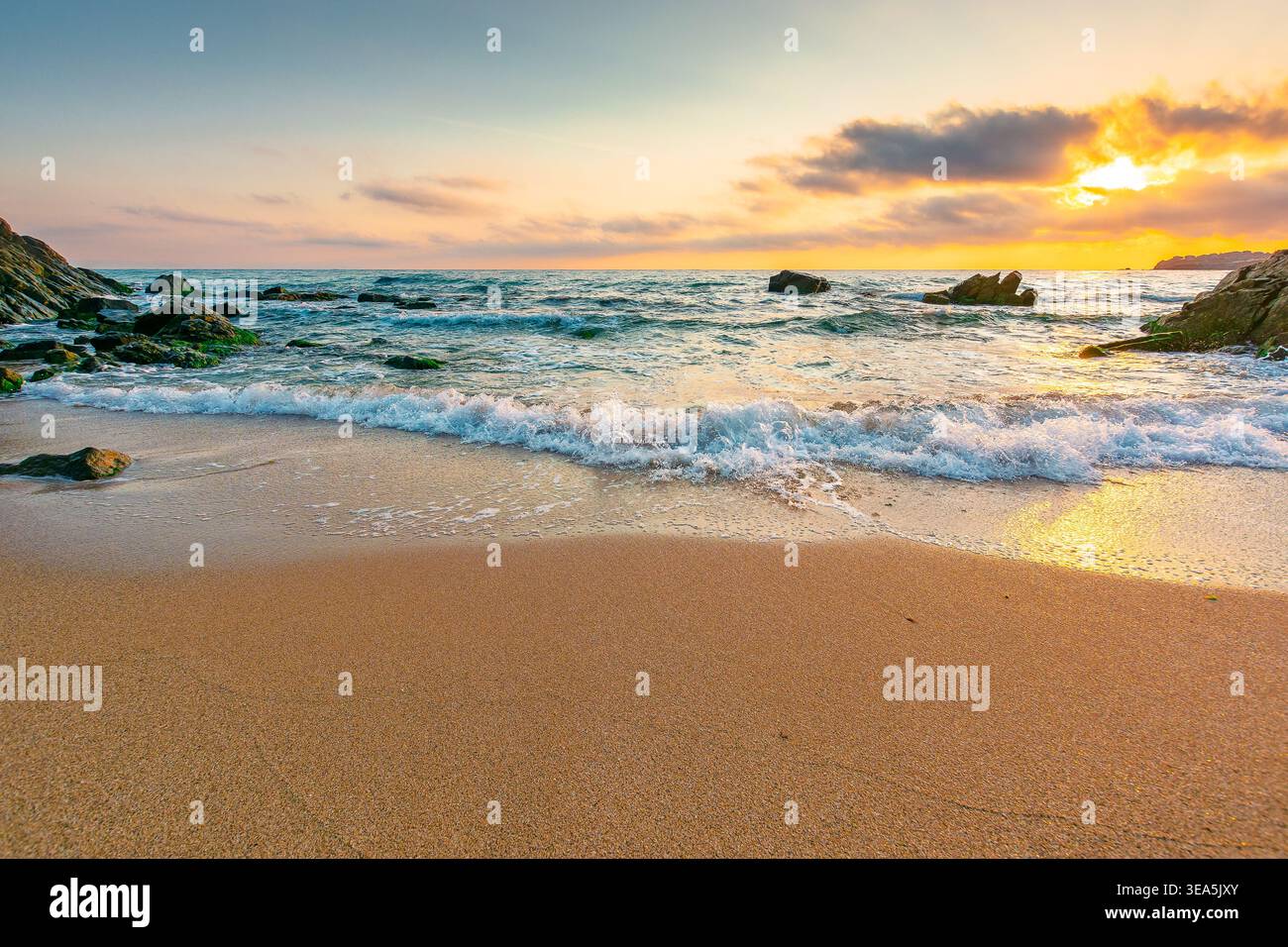 sandy beach of a black sea at sunrise. bulgaria scene on hot summer vacation season. beautiful view of waves washing the sand in morning light. generi Stock Photo