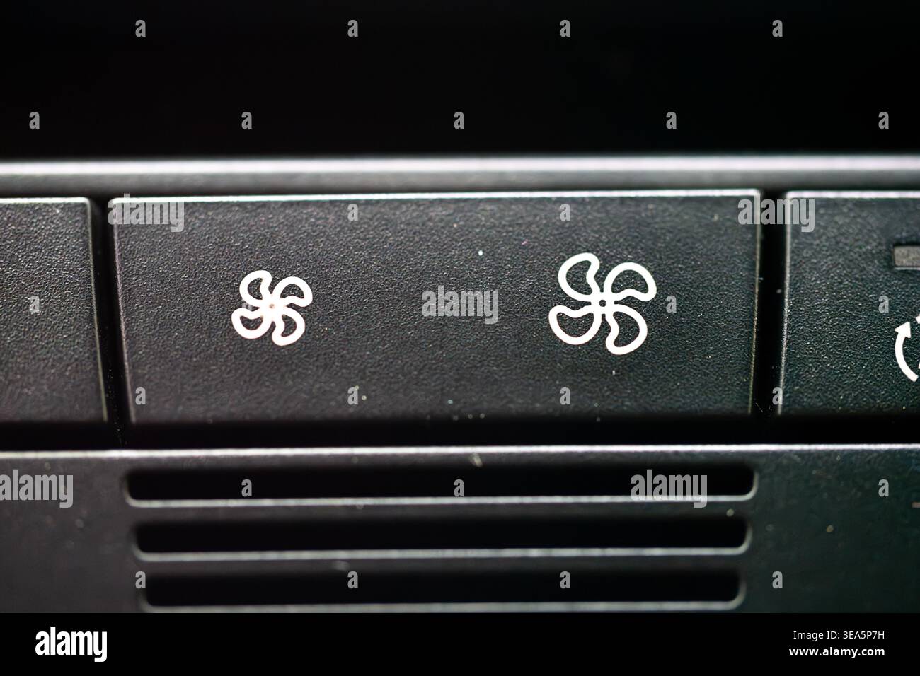 Macro close up of black car dashboard buttons with white fan speed ...