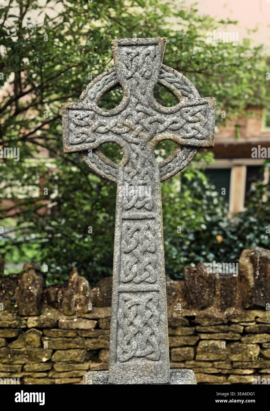 Celtic cross gravestone in St Peter's churchyard, Sharnbrook, Bedfordshire - a Christian symbol for eternal life, faith, and Irish or Celtic heritage Stock Photo