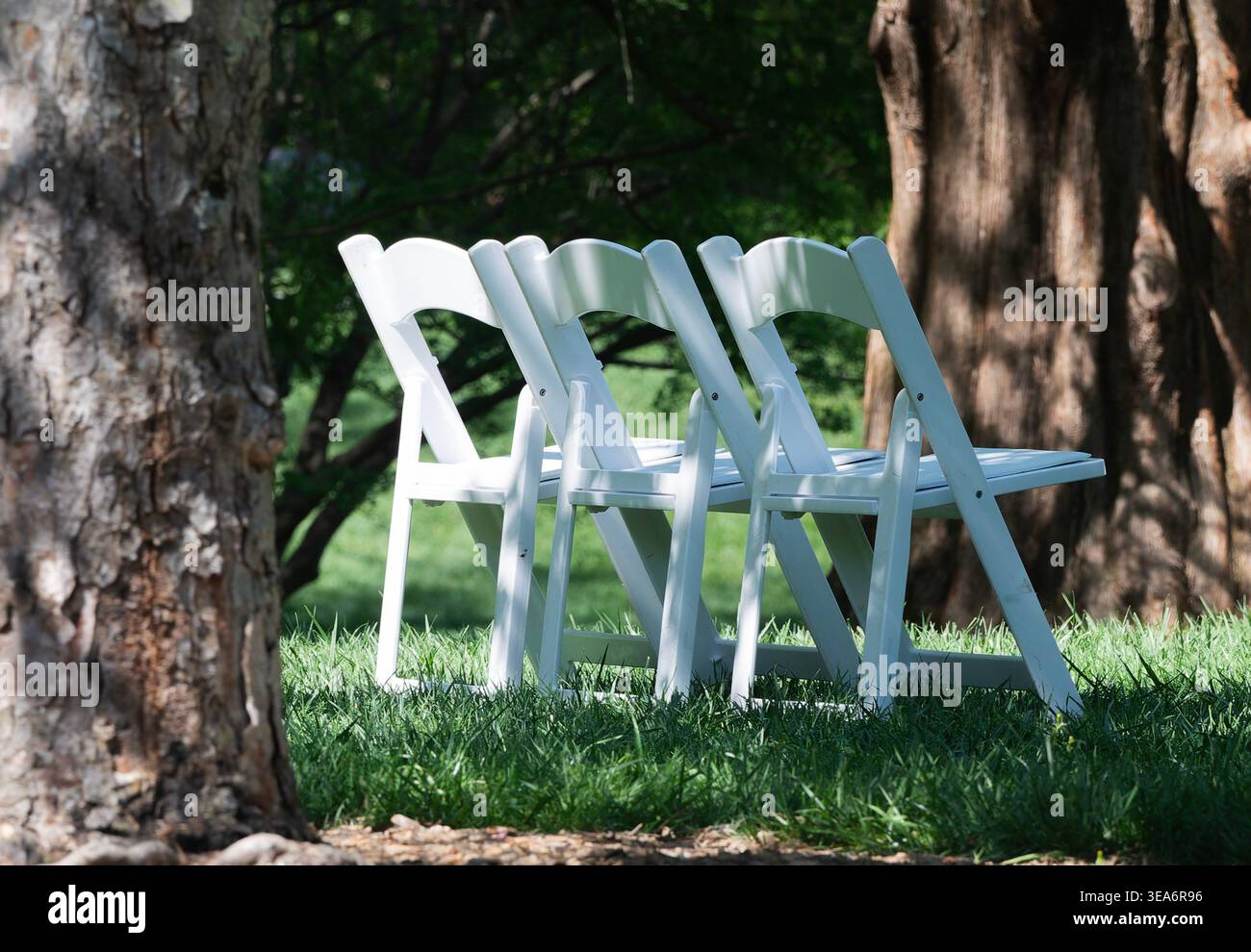 Wooden folding chairs in a park setting Stock Photo