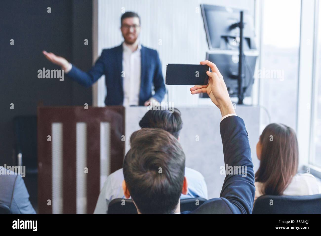 Entrepreneur recording lecture on smartphone camera, back view Stock Photo