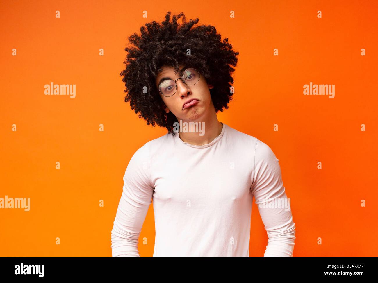 Funny upset african guy pouting lips, looking offended Stock Photo