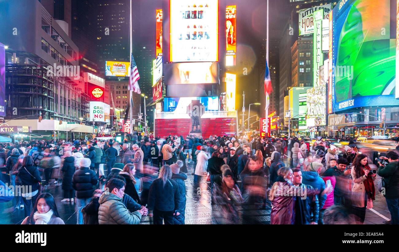 Times Square at night in New York City with billboards illuminated in ...