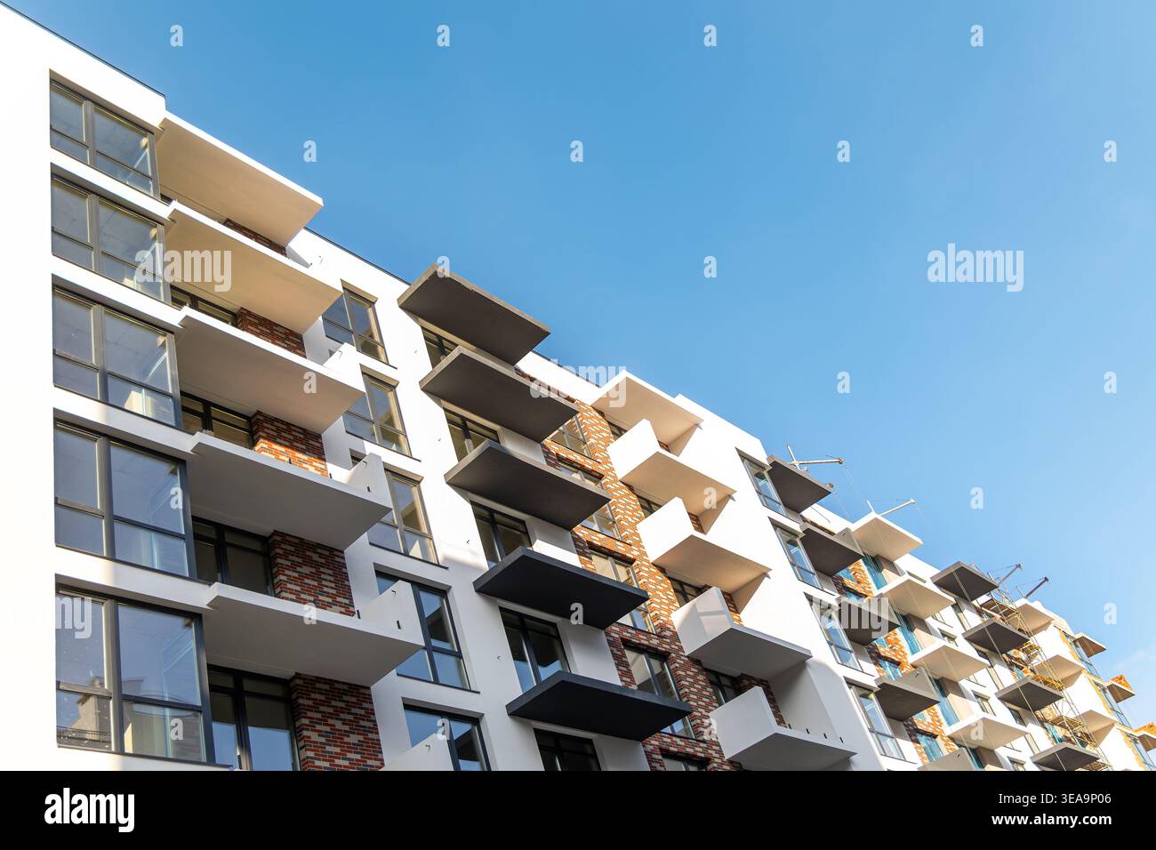 Modern Apartment Building With Balconies and Blue Sky. Low angle view ...
