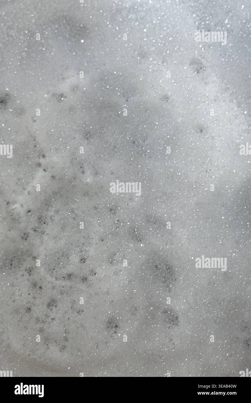 Soap suds create an organic, textured background that resembles a nebula scene from outer space. Stock Photo