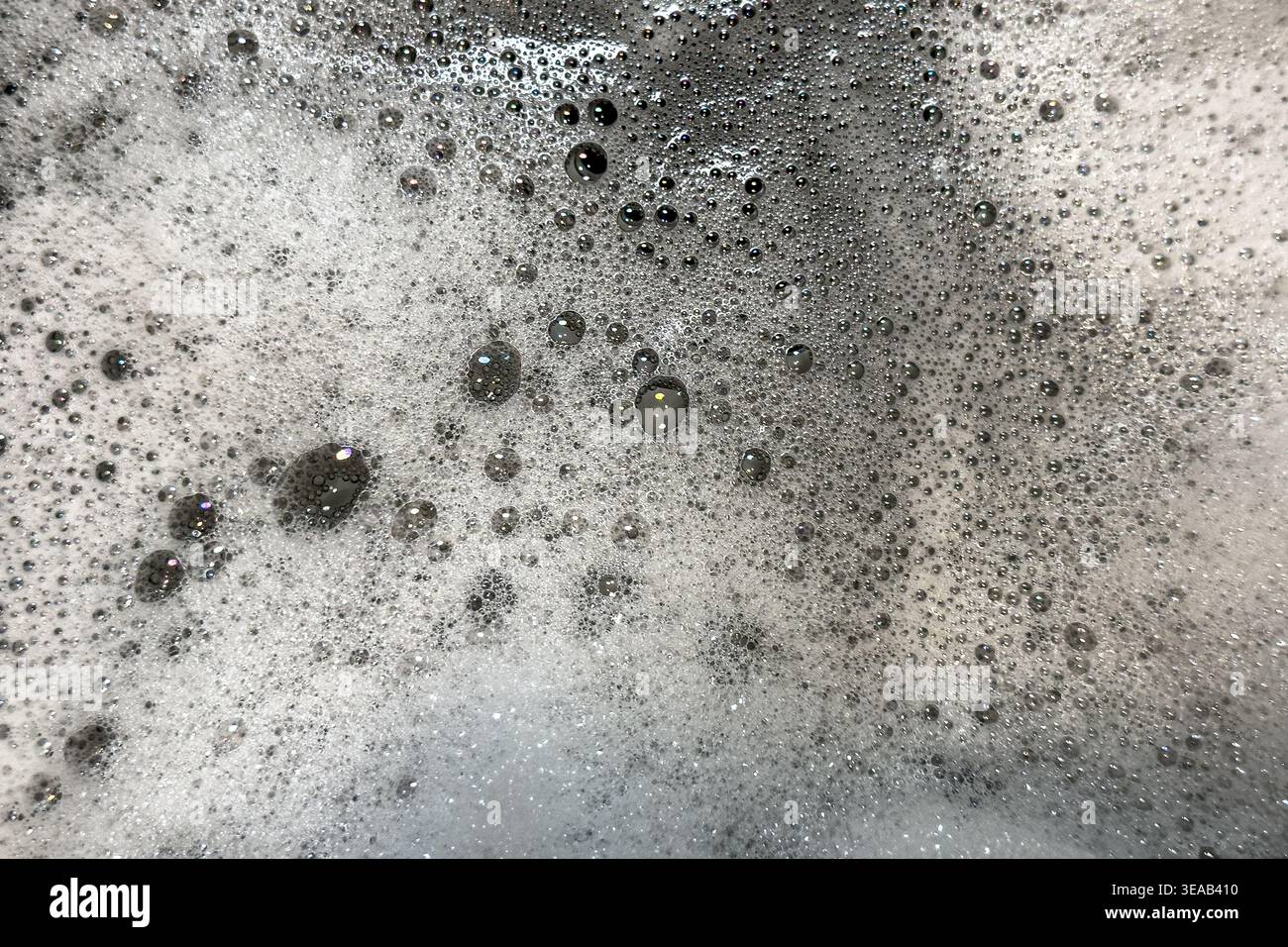 Soap suds bubbles and foam create an organic, textured background element. Stock Photo
