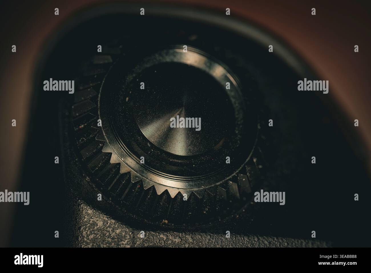 Macro closeup of camera shutter button with textured dial and gear detail showing precision photography control and metal surface Stock Photo