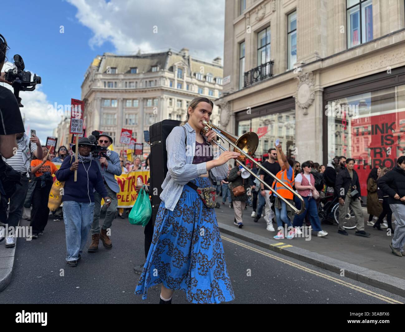 A woman plays the trumpet at the National Housing Demonstration in London, UK, on 18 April 2026 - Smartphone Captured Stock Image
