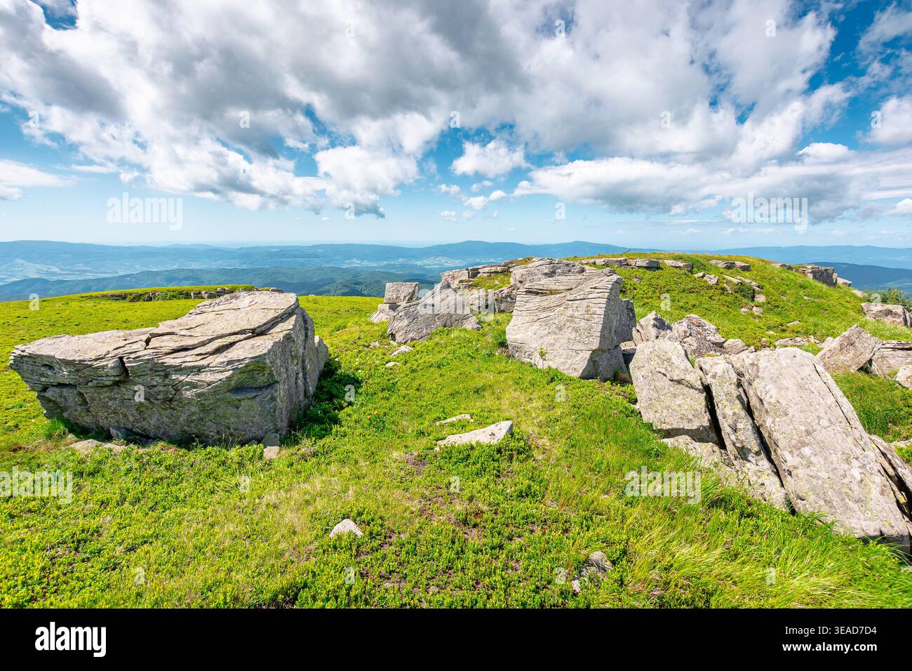 mountainous carpathian landscape during summertime. boulders and rock formations surrounded grassy hills. picture of a sunny forenoon with clouds on t Stock Photo