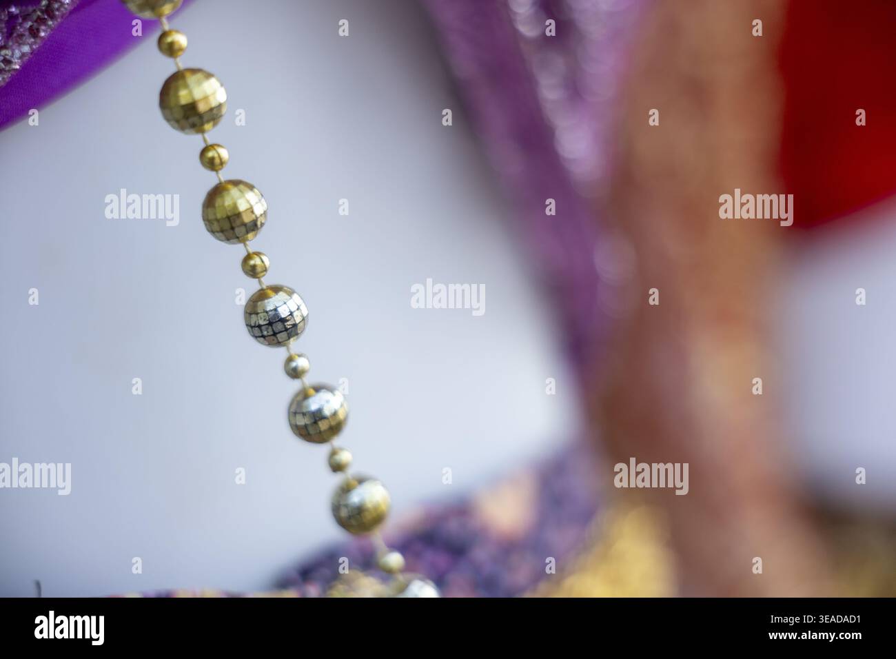 Purple dress with gold necklace hi-res stock photography and images - Alamy