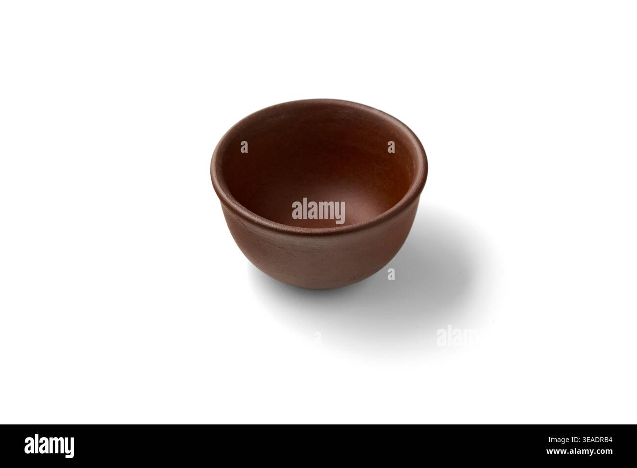 Empty clay brown bowl isolated on white background. Stock Photo