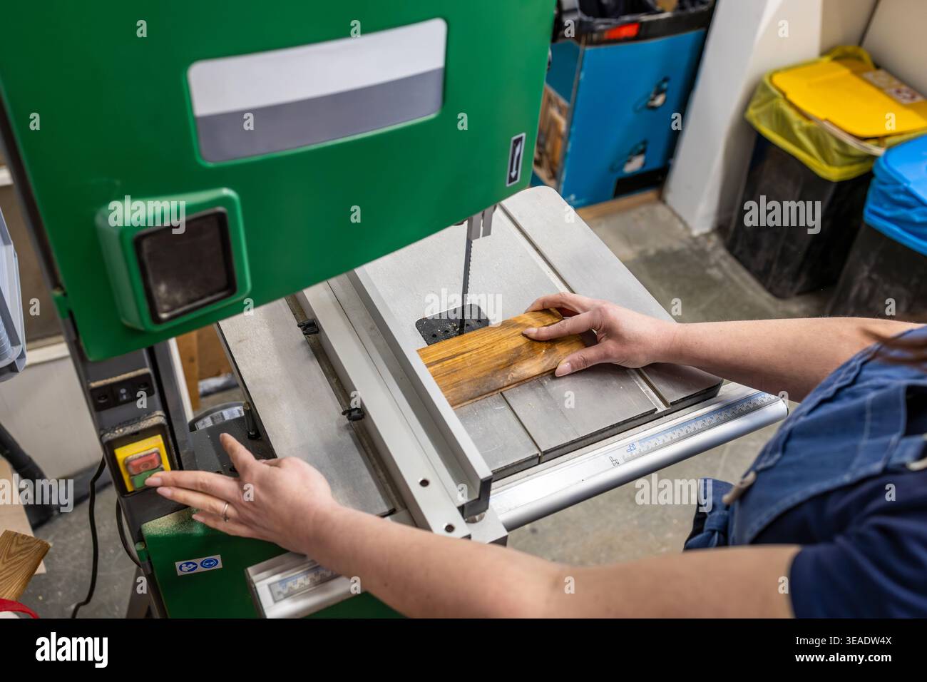 Woman Operating Woodworking Machine in Carpentry Studio Stock Photo