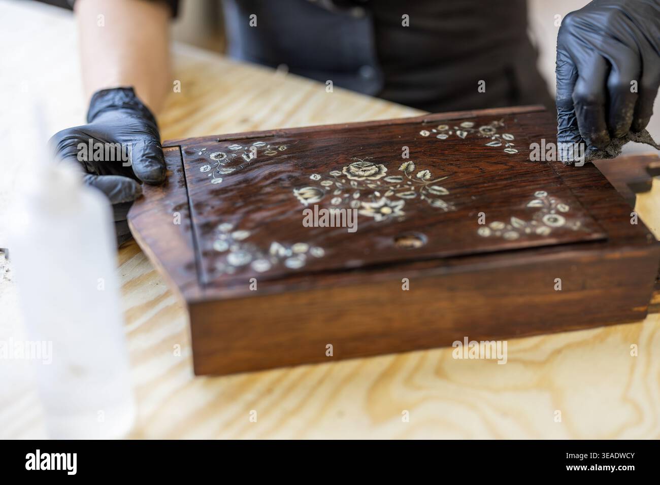 Restoring Decorated Wooden Box with Hand Tools on Workbench Stock Photo
