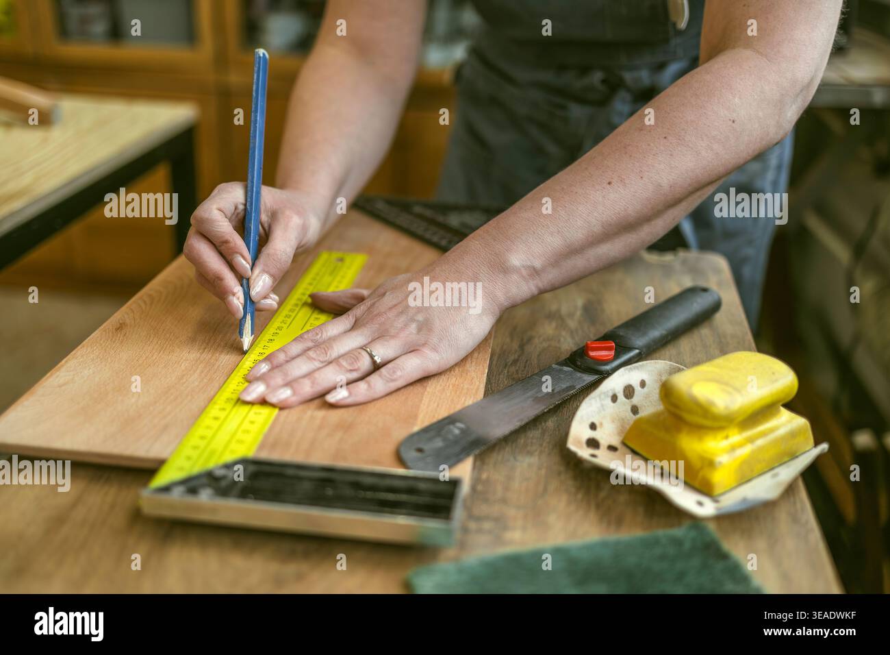 Measuring Wooden Element with Ruler in Workshop Stock Photo