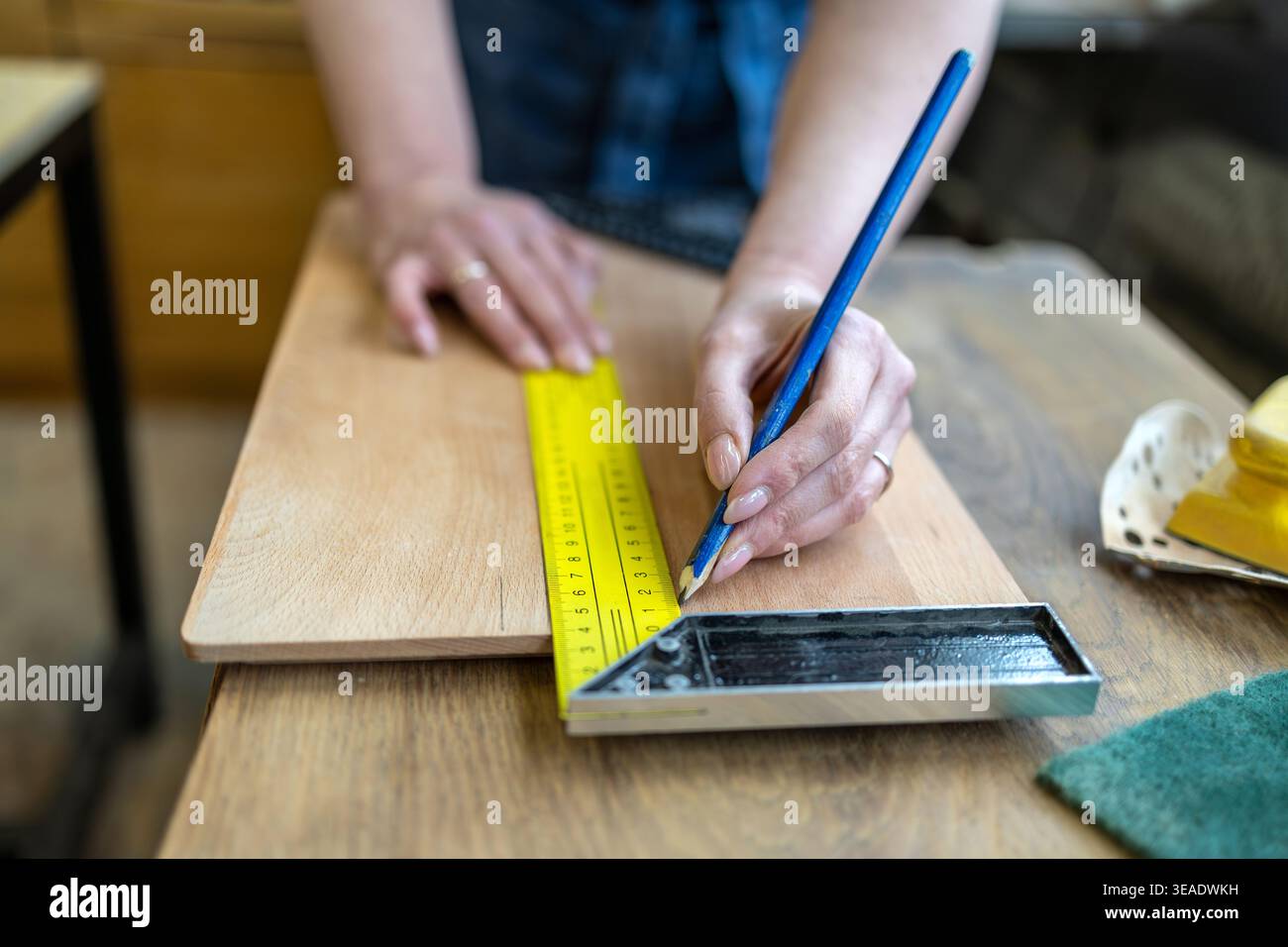Measuring Wooden Element with Ruler in Workshop Stock Photo