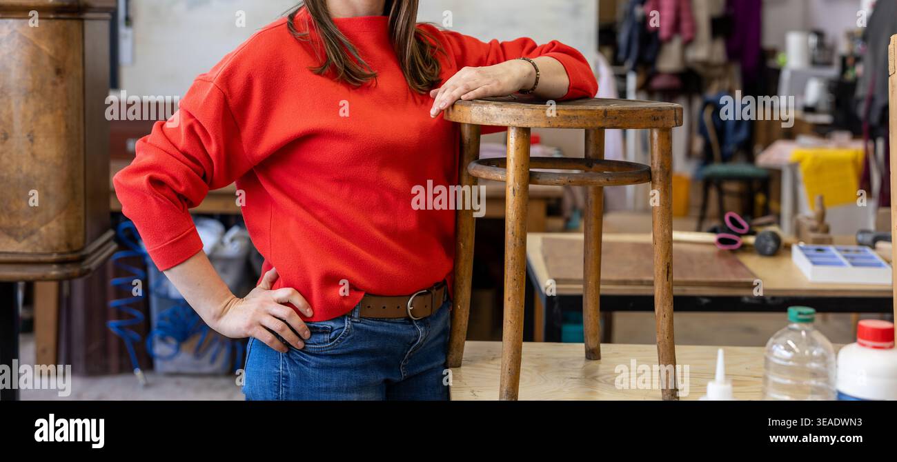 Female Carpenter Standing in her Workshop Stock Photo