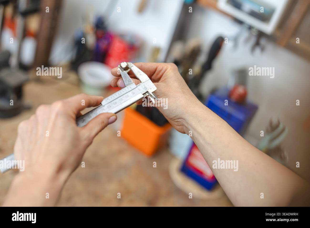 Measuring Small Component with Caliper in Workshop Stock Photo