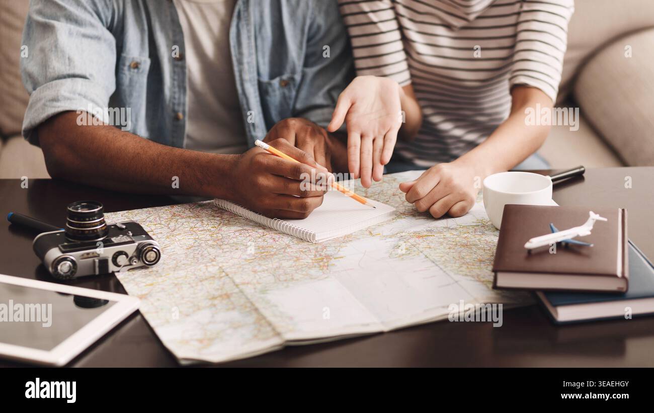 Couple planning vacation, making notes in diary Stock Photo