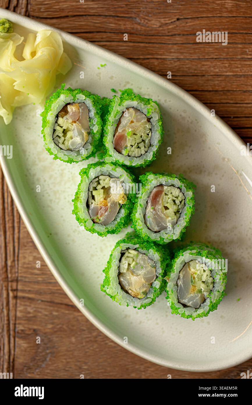 Sushi rolls with green coating and ginger Stock Photo