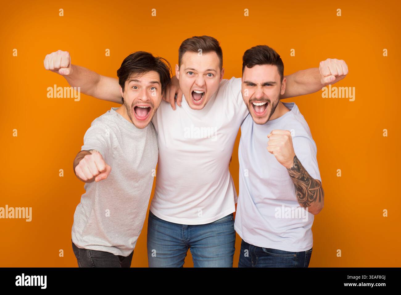 Yes. Cheerful men shouting and celebrating victory Stock Photo
