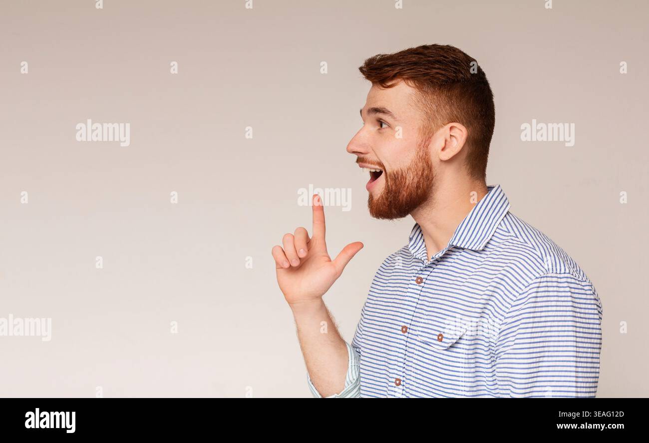 Young excited man having good idea and feeling happy Stock Photo