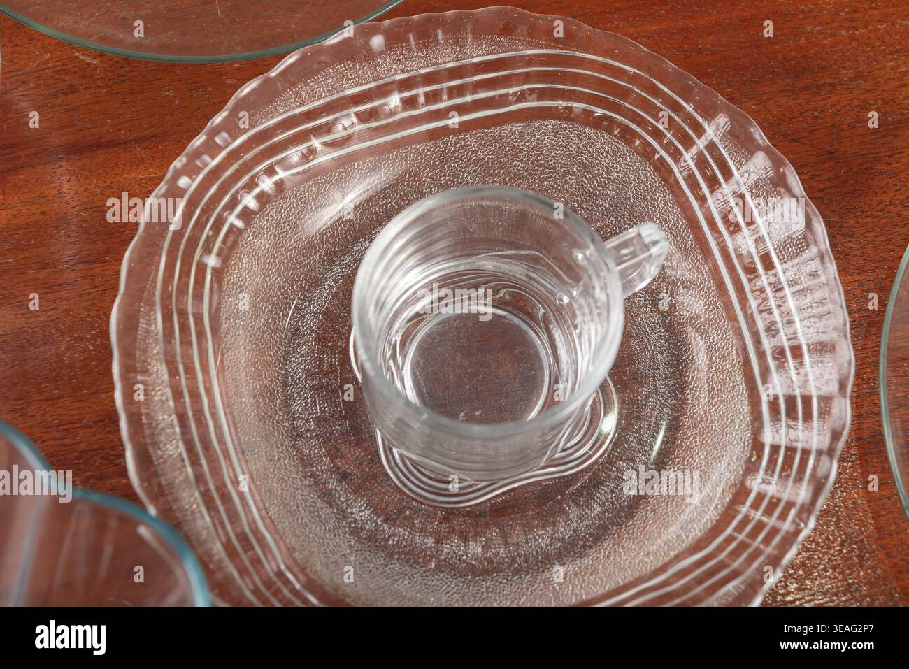Crystal cup placed on crystal plate. Soft studio lighting, reflective ...