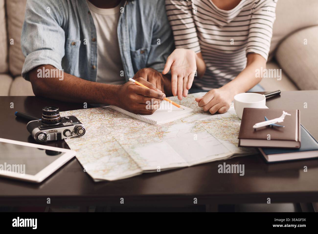 Couple planning vacation, making notes in diary Stock Photo