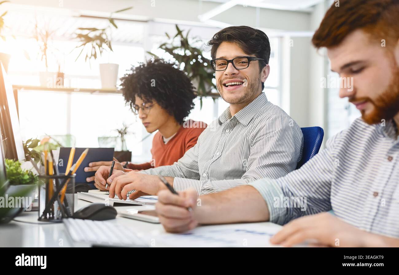 Team Members Collaborate in a Bright Office Environment While Working on Projects Stock Photo