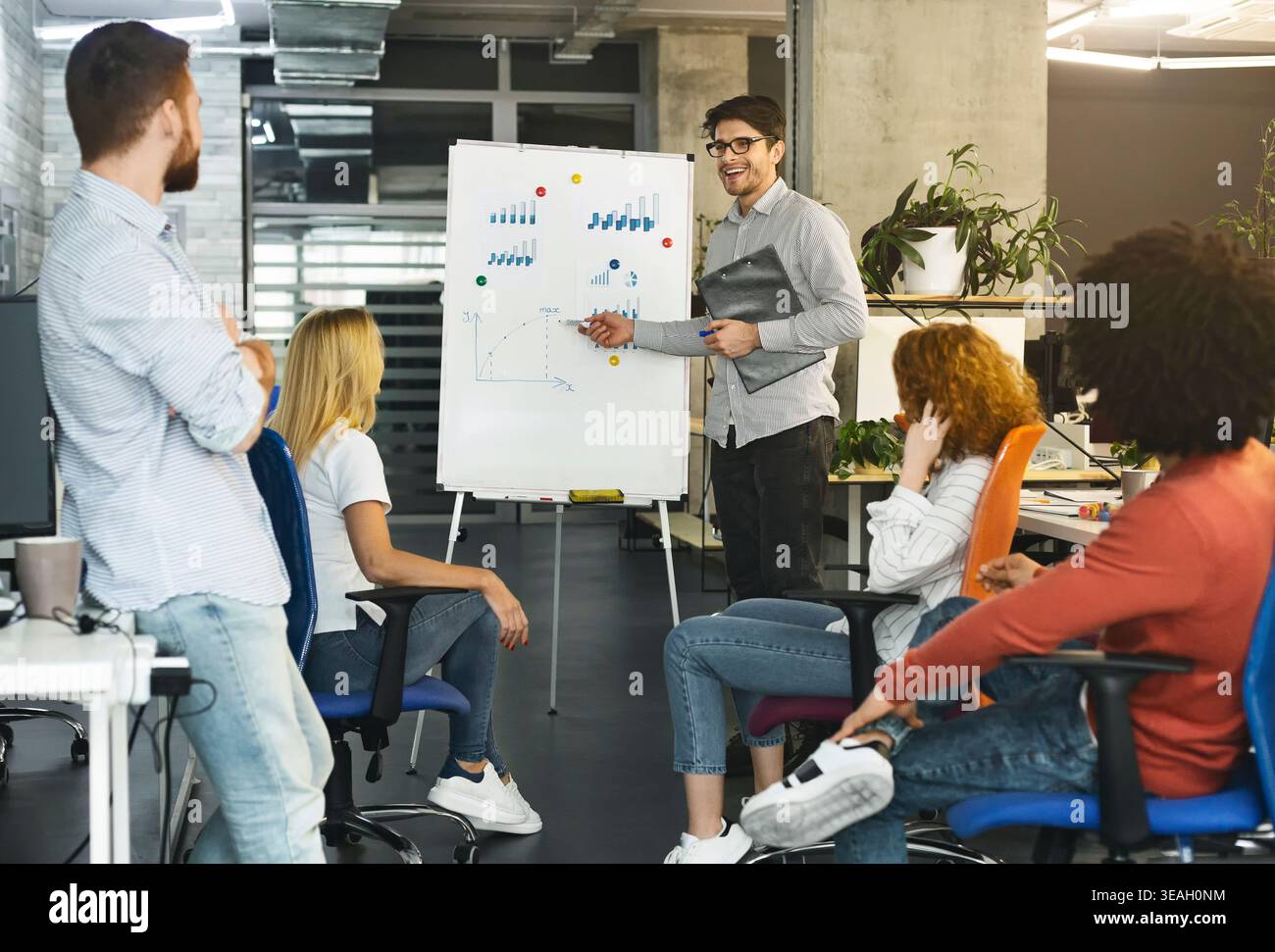 Team Engagement in a Modern Office During a Collaborative Strategy Session Stock Photo