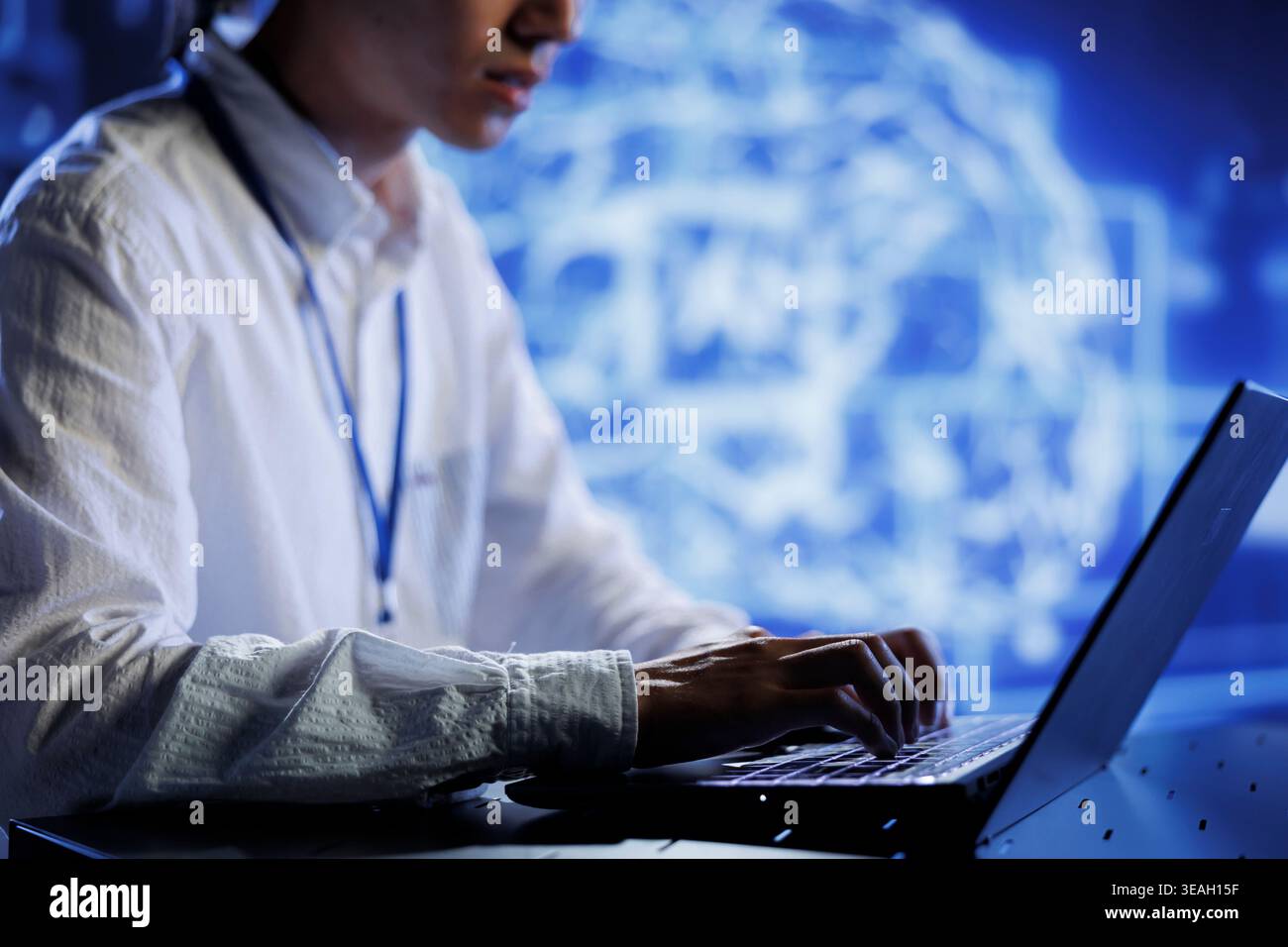 Computer scientist in data center uses artificial intelligence computing simulating human brain through self learning algorithms. System administrator with laptop working with AI deep neural networks Stock Photo