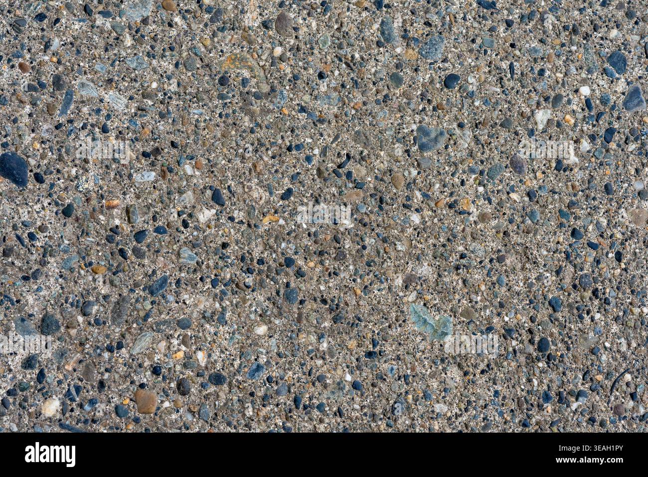 Full Frame Exposed Aggregate Concrete Texture: Dark Gray Ground Surface with Colorful Pebbles Stock Photo
