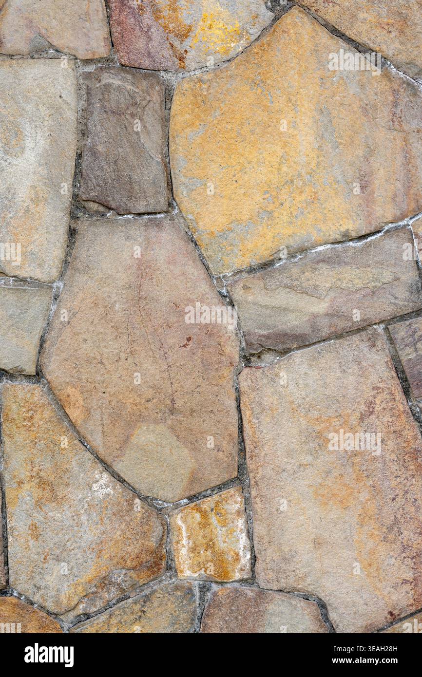 Architectural Background: Natural Stone Cladding Surface with Uneven Edges and Cement Grout Stock Photo